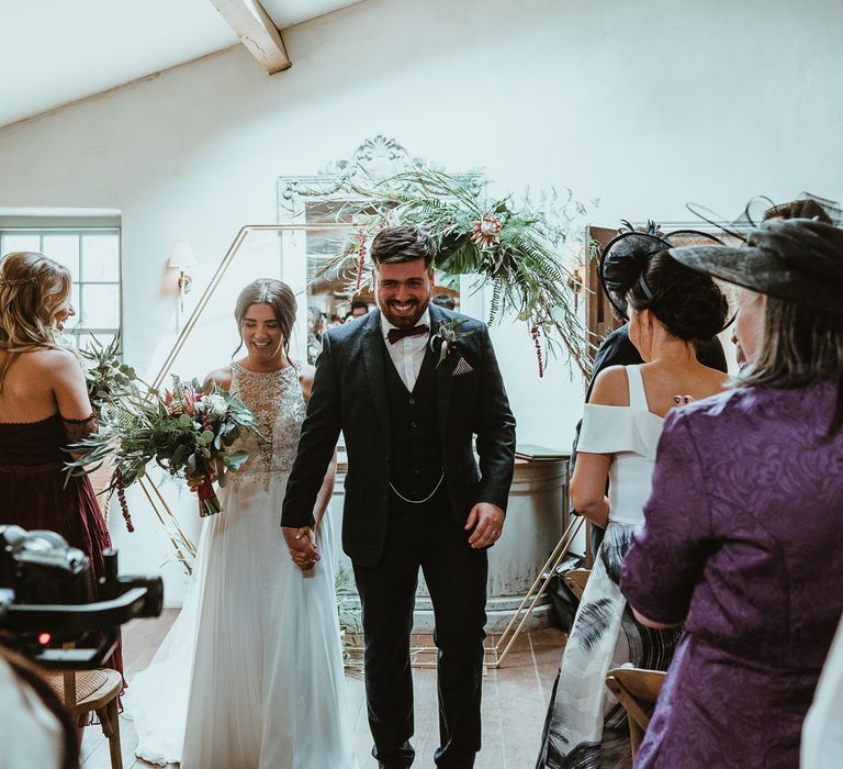 Bride and Groom Walking up the Altar as Husband and Wife