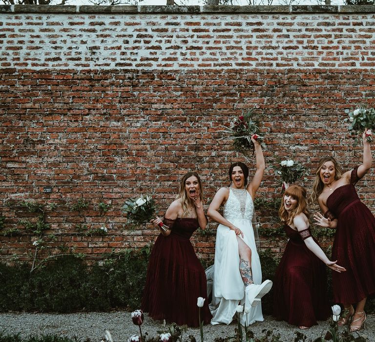 Bride in white Dr Martins and Maggie Sottero Weding Dress and Bridesmaids in Burgundy ASOS dresses