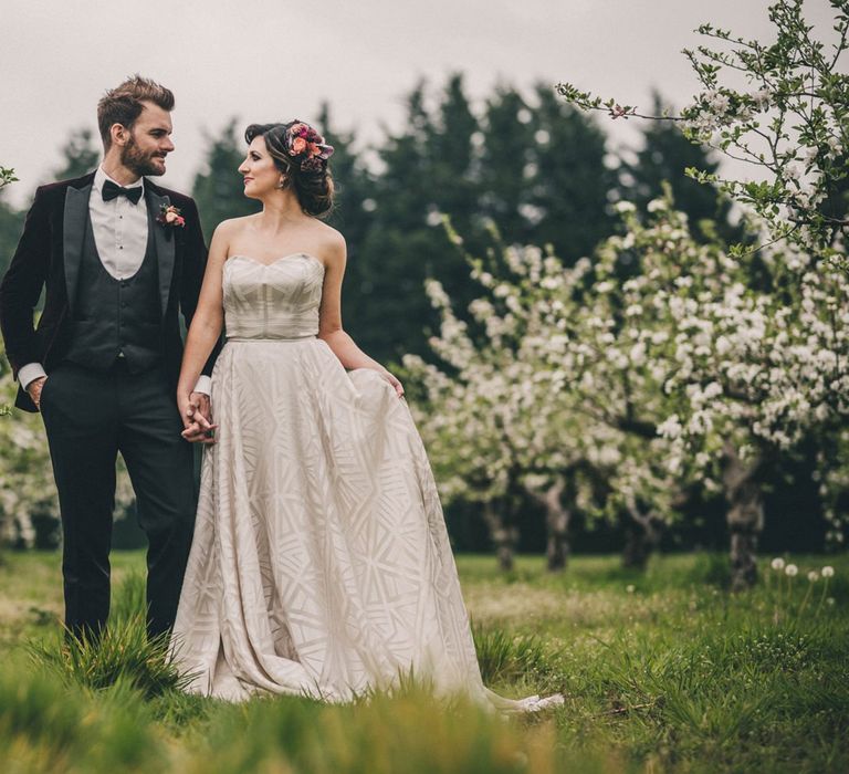 Black Tie Wedding Attire with Groom in Tuxedo and Bride in Sweetheart Neckline Wedding Dress with Geometric Pattern