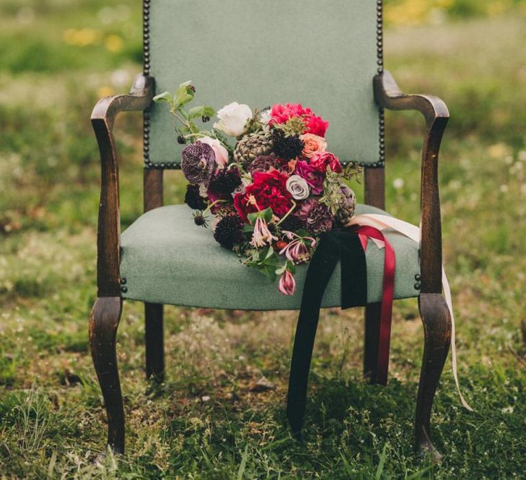 Burgundy, Red and Pink Wedding Bouquet Resting on a Chair