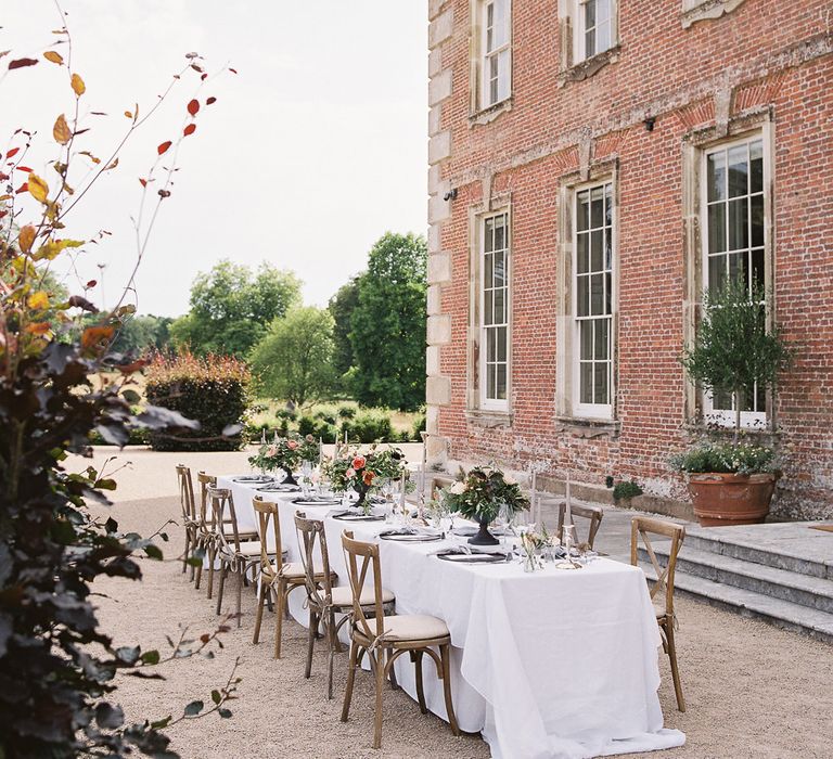 Outdoor Tablescape with Living Coral, White &amp; Greenery Floral Centrepieces | Elegant Summer Inspiration at St Giles House, Dorset by Jessica Roberts Design   Imogen Xiana Photography