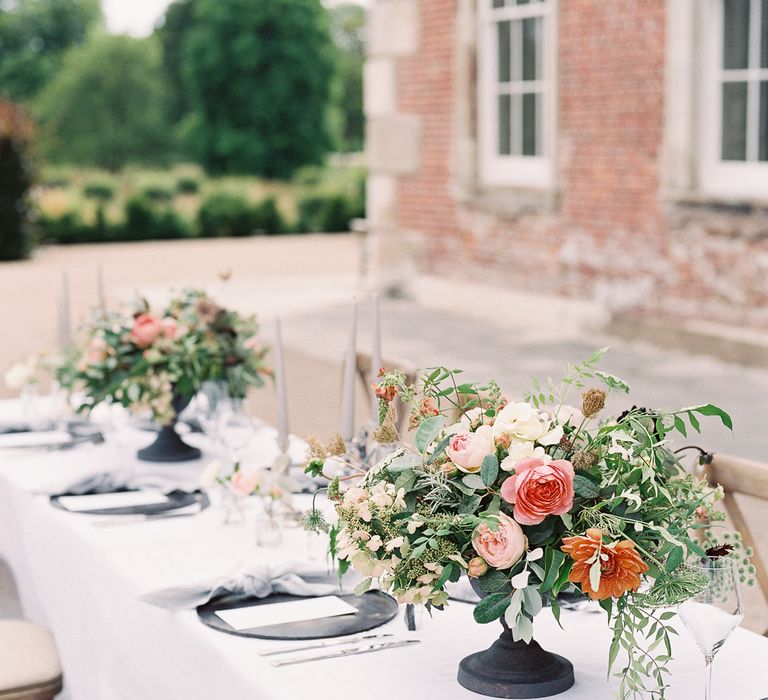 Outdoor Tablescape with Living Coral, White &amp; Greenery Floral Centrepieces | Elegant Summer Inspiration at St Giles House, Dorset by Jessica Roberts Design   Imogen Xiana Photography