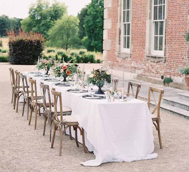 Outdoor Tablescape with Living Coral, White &amp; Greenery Floral Centrepieces | Elegant Summer Inspiration at St Giles House, Dorset by Jessica Roberts Design   Imogen Xiana Photography