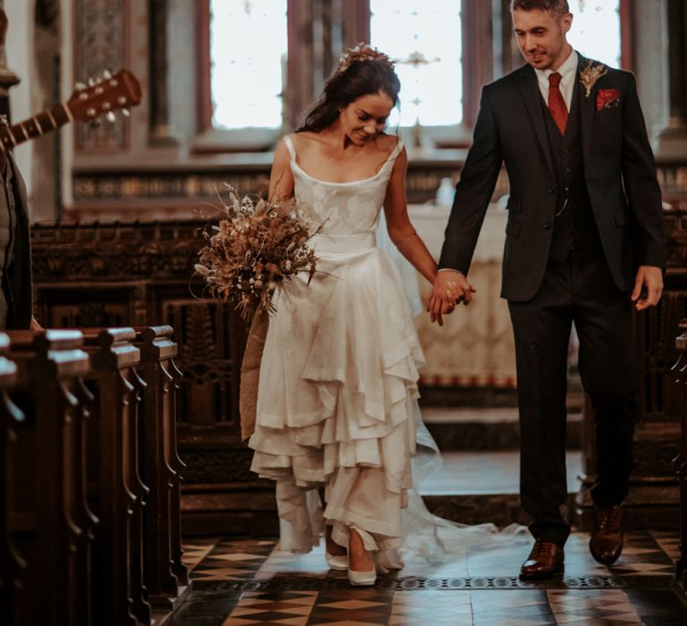 Bride and groom, walking down the aisle as husband and wife