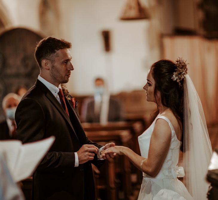 Bride and groom exchanging vows at intimate micro wedding