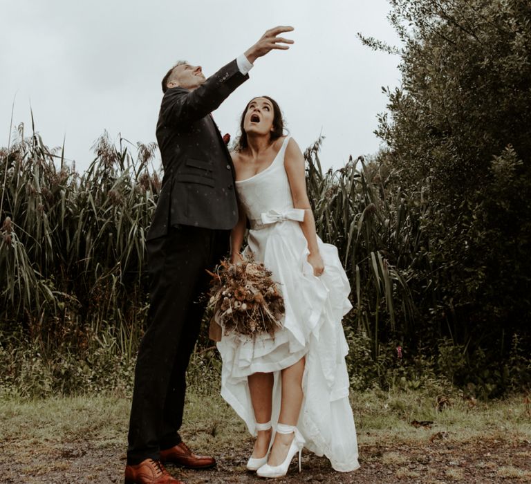 Bride and groom portrait in the rain