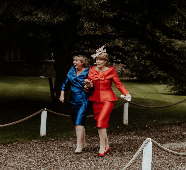 Mother of the bride and groom in red and blue dresses