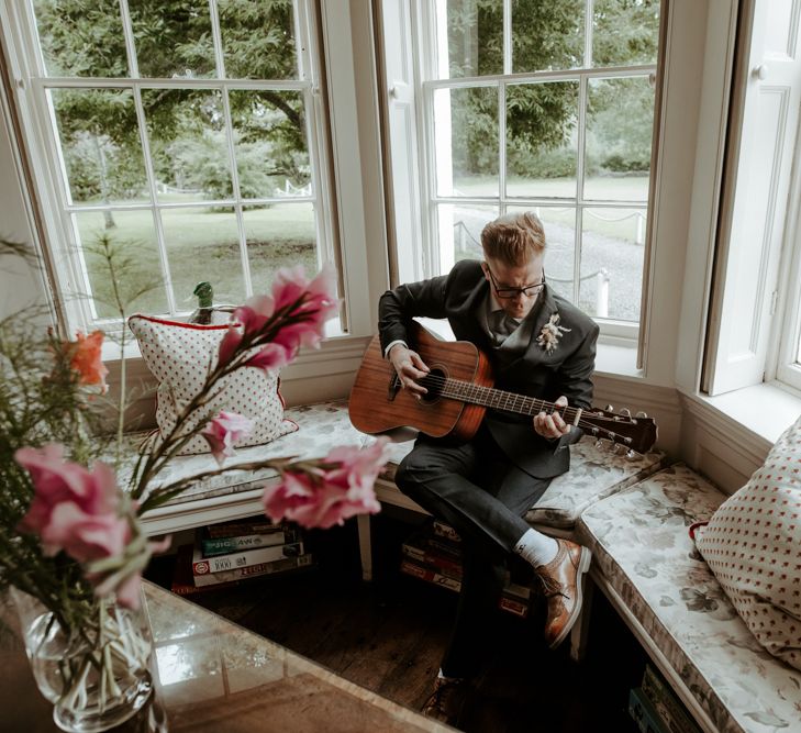 Wedding guest playing guitar