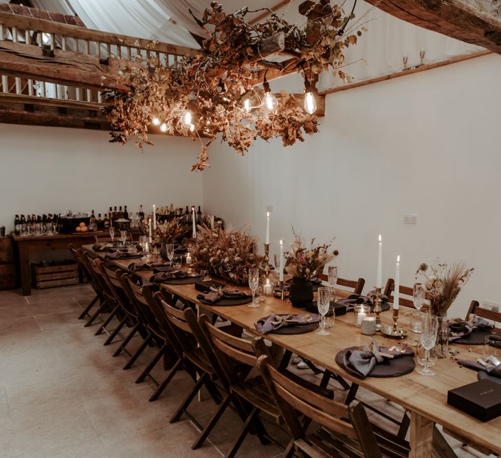 Intimate wedding reception  with Autumnal wedding decor and festoon lights