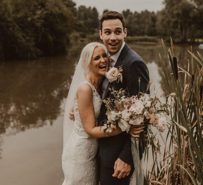 Bride clutches blush bouquet with her new husband