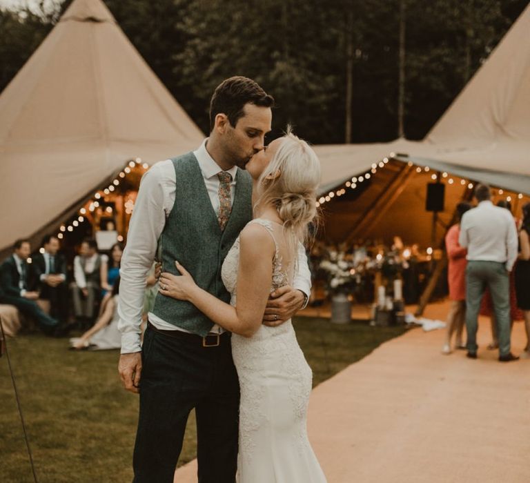 Bride and groom outside teepee for wedding