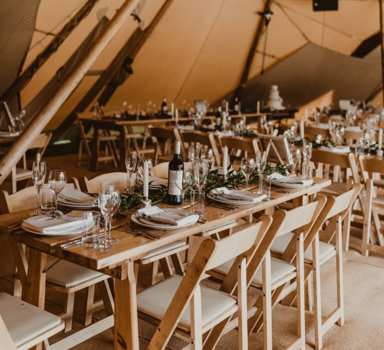 Teepee for wedding reception with foliage decor