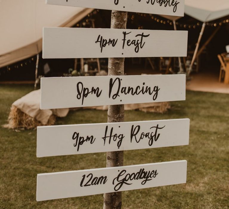 Wooden order of the day wedding sign at Teepee for wedding