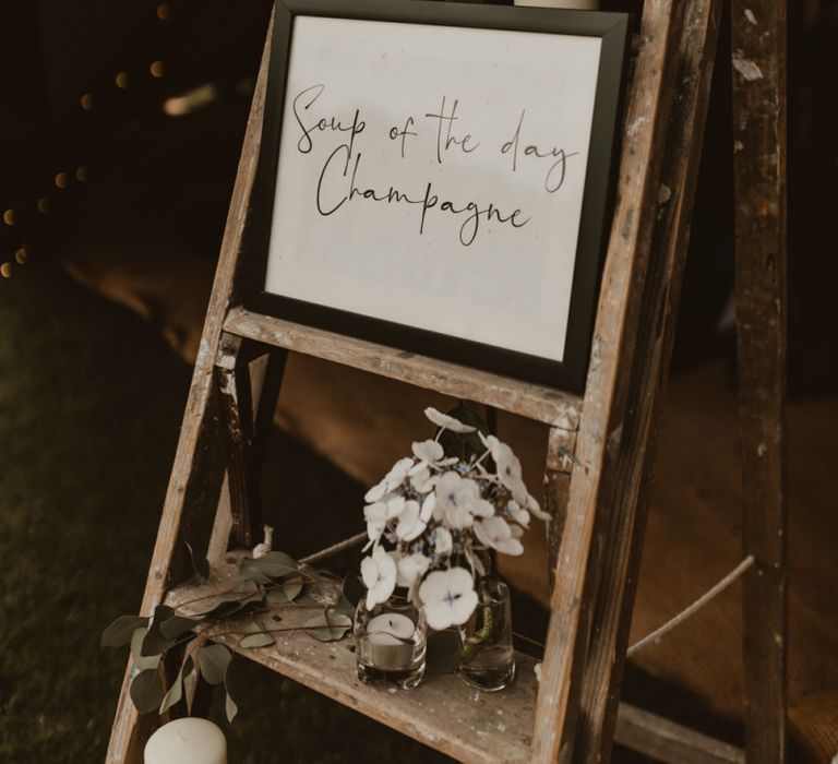 Wedding sign and stepladder decor at Teepee for wedding reception