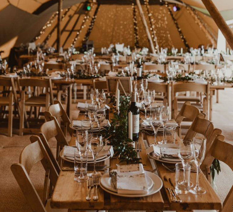 Teepee for wedding reception with foliage decor