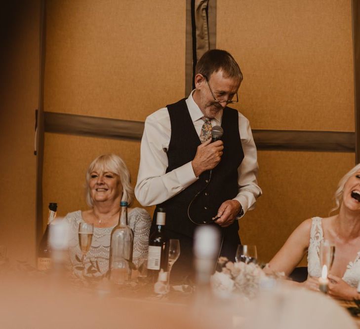 Bride laughs at wedding speeches