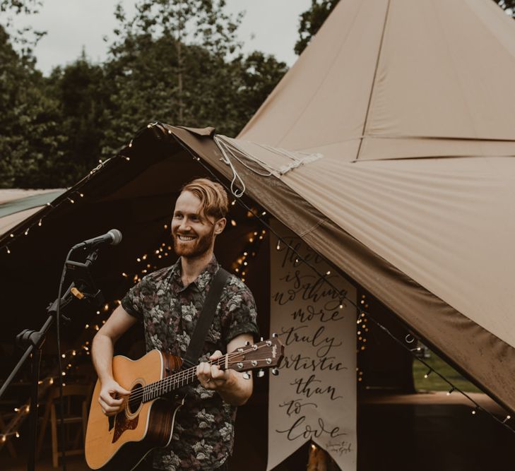 Acoustic singers outside teepee for wedding