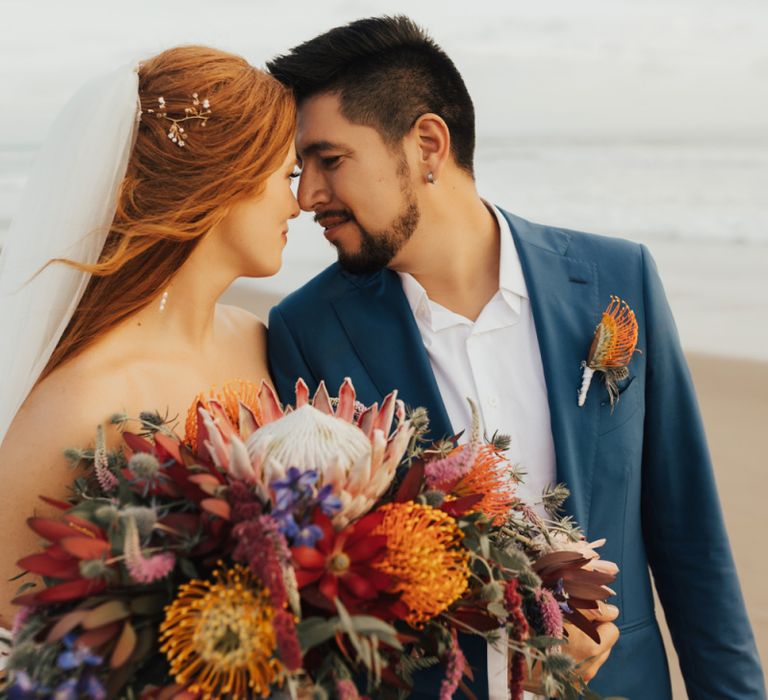 Bride and Groom After Ceremony With Veil and Navy Suit