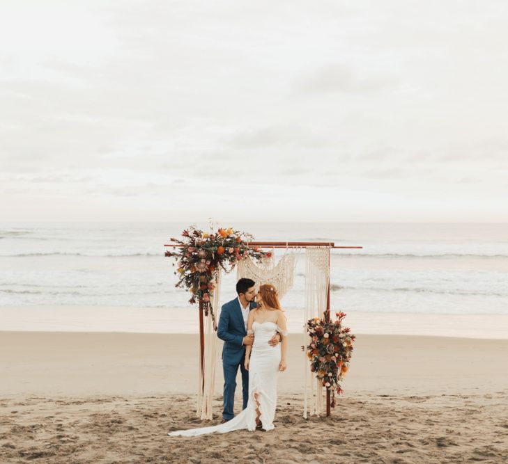 Bride and Groom Under Macrame and Flowers