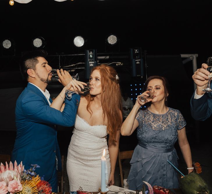 Bride and Groom Link Arms To Drink Champagne