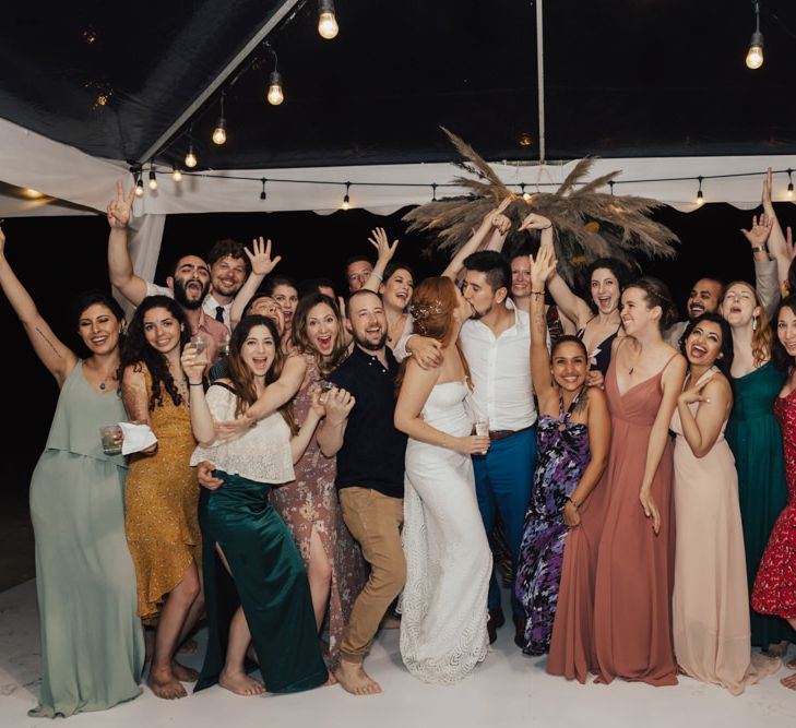 Bride and Groom With All Their Guests During The Evening Celebration