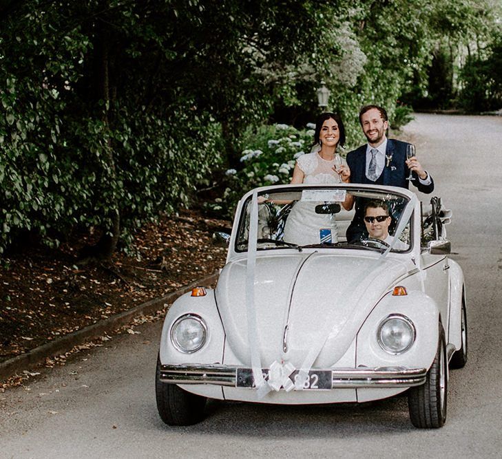 Vintage wedding car with bride and groom