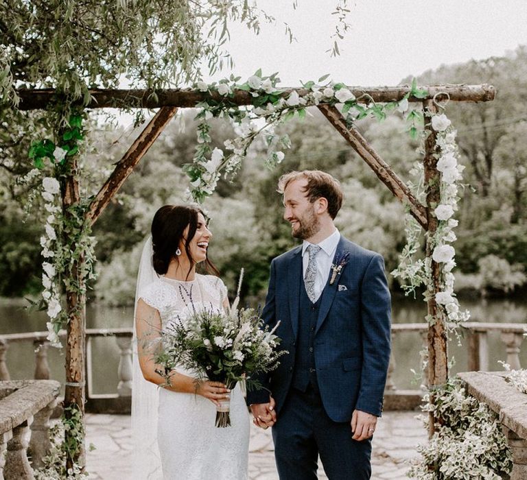 Bride in Jesus Peiro wedding dress with groom in blue wedding suit