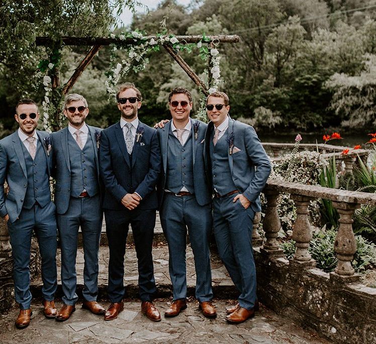 Groom with groomsmen in matching blue wedding suits