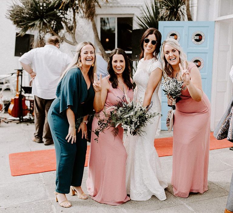 Bride in Jesus Peiro wedding dress with wedding guests and bridesmaids