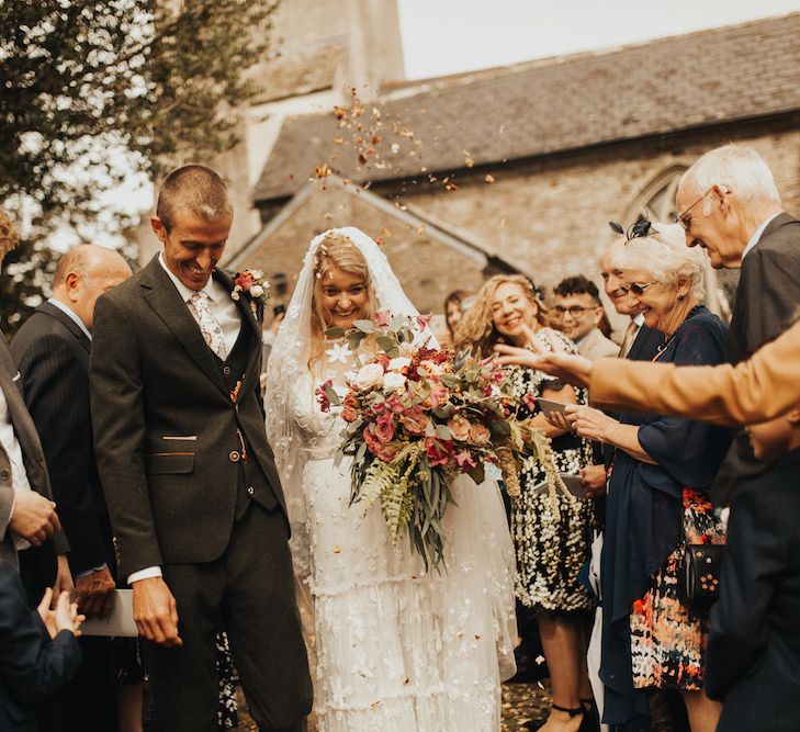 Confetti exit for groom and bride in Eliza Jane Howell wedding dress