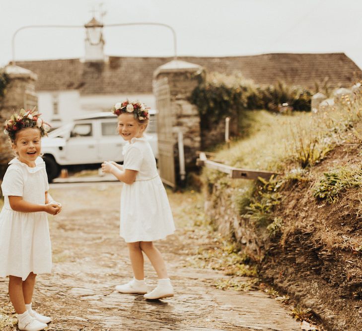 Flower girls in flower crowns and white dresses