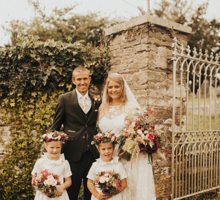 Bride in Eliza Jane Howell wedding dress with groom and flower girl daughters