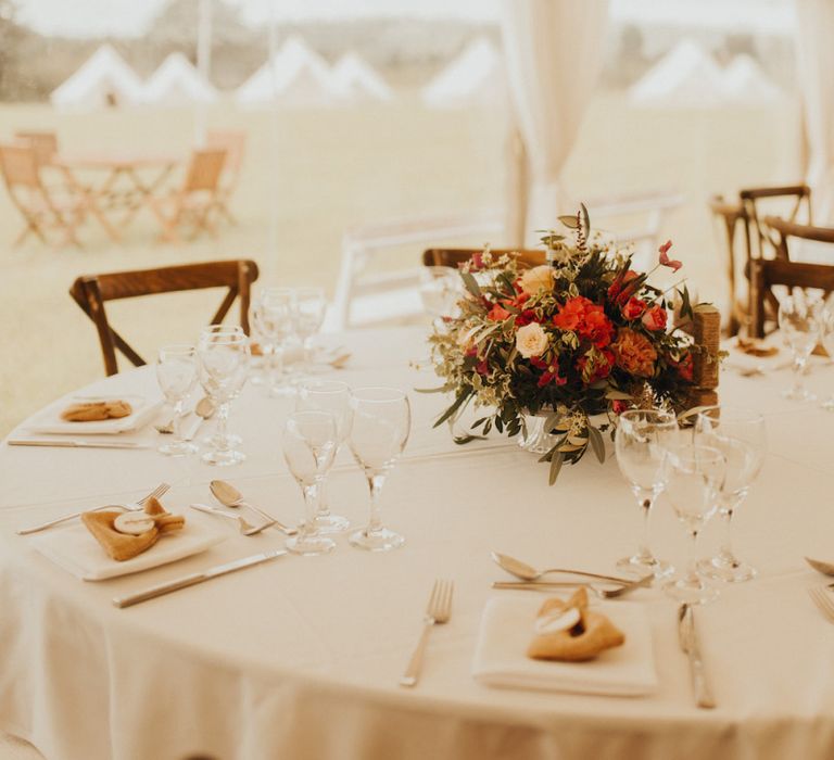 Rust coloured wedding flowers at marquee wedding with bride wearing Eliza Jane Howell wedding dress