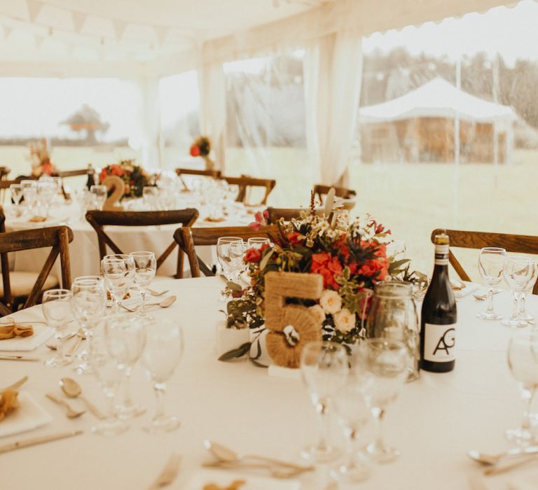 Rust coloured wedding flowers at marquee wedding with bride wearing Eliza Jane Howell wedding dress