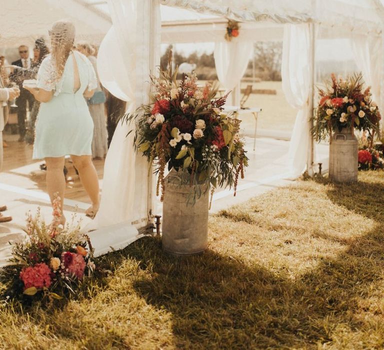 Wedding flowers at marquee entrance