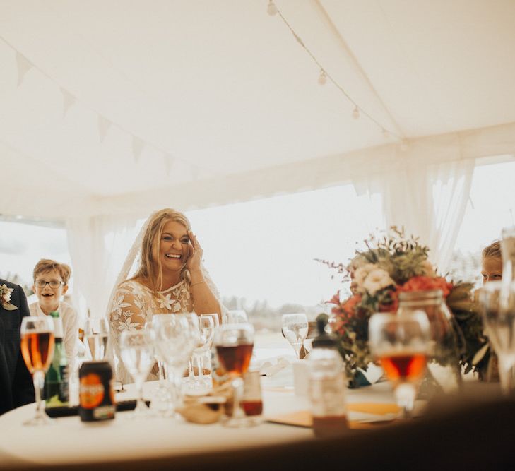 Bride in Eliza Jane Howell wedding dress enjoying the wedding speeches