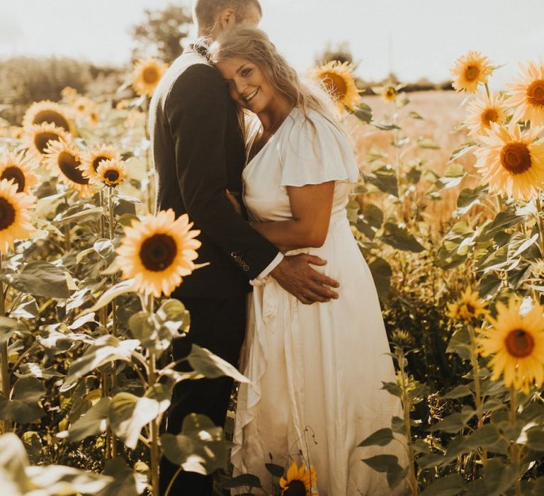 Bride and groom in sunflower field