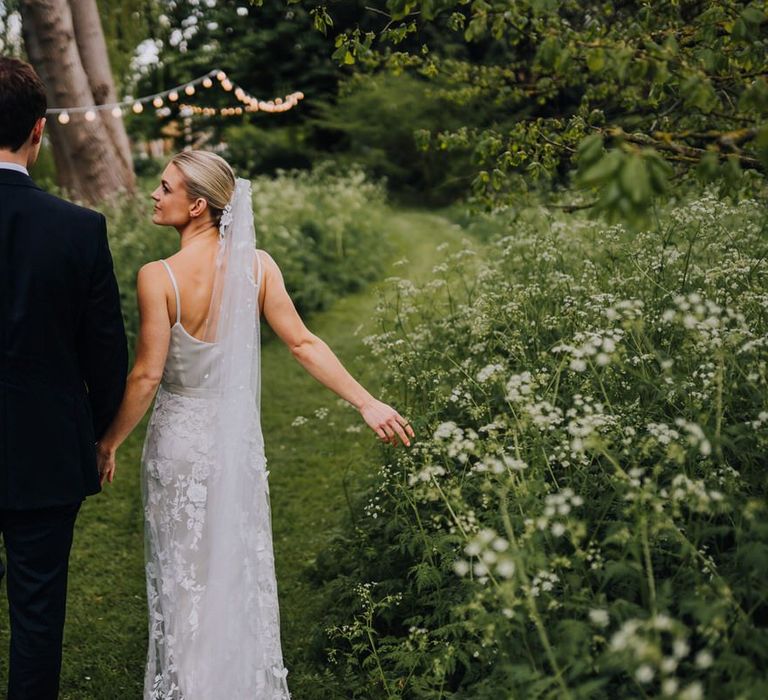 Bride and Groom Walking Through Orchard Filled with Cow Parsley and Bridal Two Piece