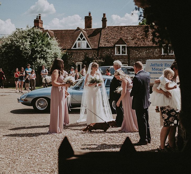 Bridal Partying Arriving at the Church in a Blue  E-Type Jaguar Wedding Car