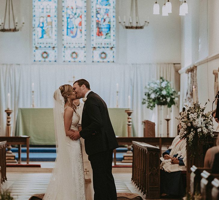 Bride and Groom Just Married Kissing at The Altar