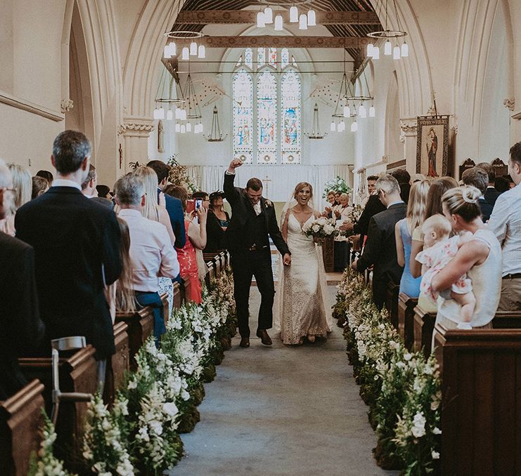 Bride and Groom Just Married Walking Up the Aisle