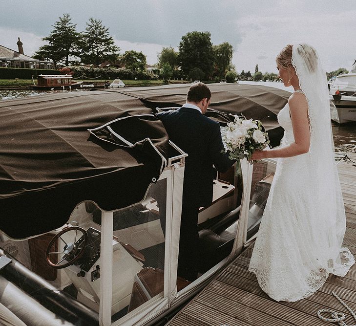 Bride and Groom Getting on a Boat to Cross The River to Their Moat Side Pub Wedding Reception