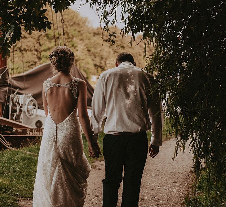 Bride and Groom Walking By The River Bank