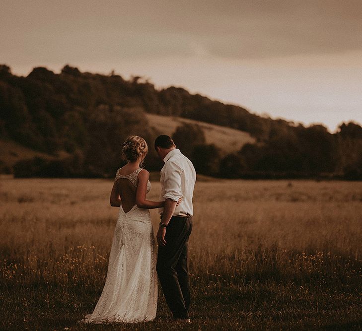 Bride and Groom Embracing in an Open Field