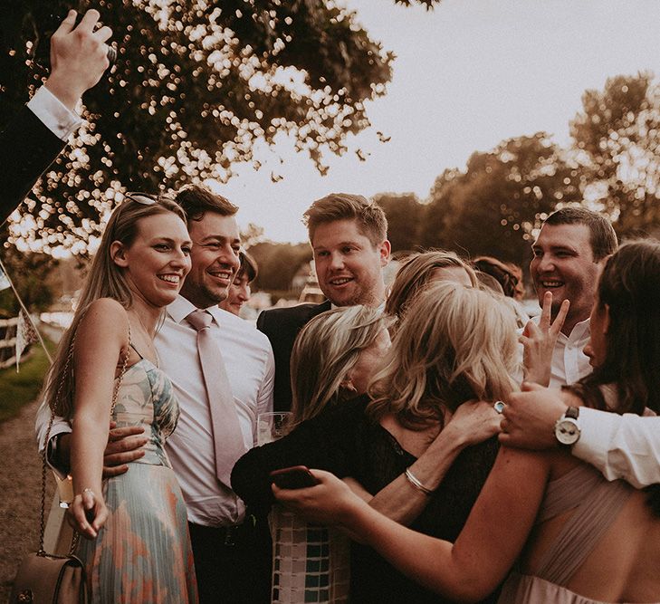 Bride and Groom Surrounded by Family and Friends