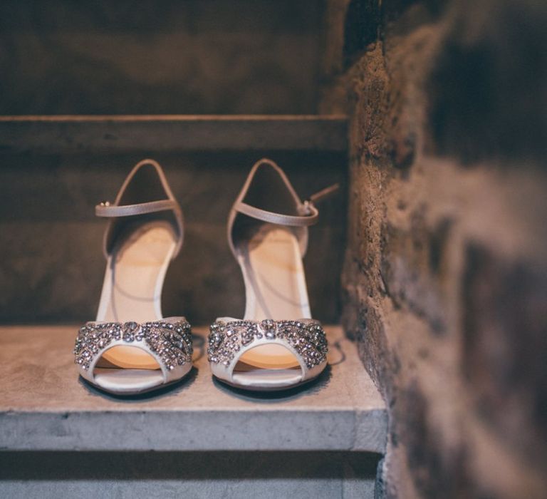 Brides shoes at city celebration with fairy light backdrop