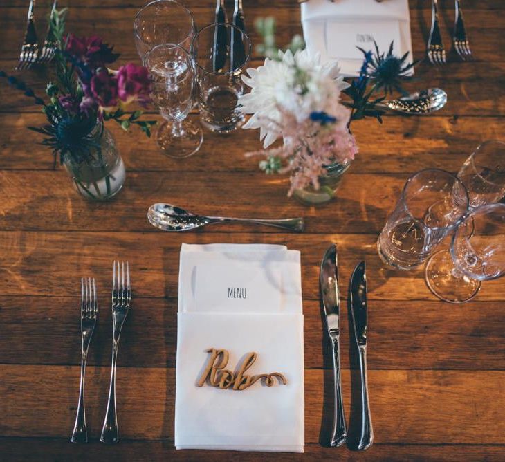 Table centrepiece with jam jar flower decor and personalised details