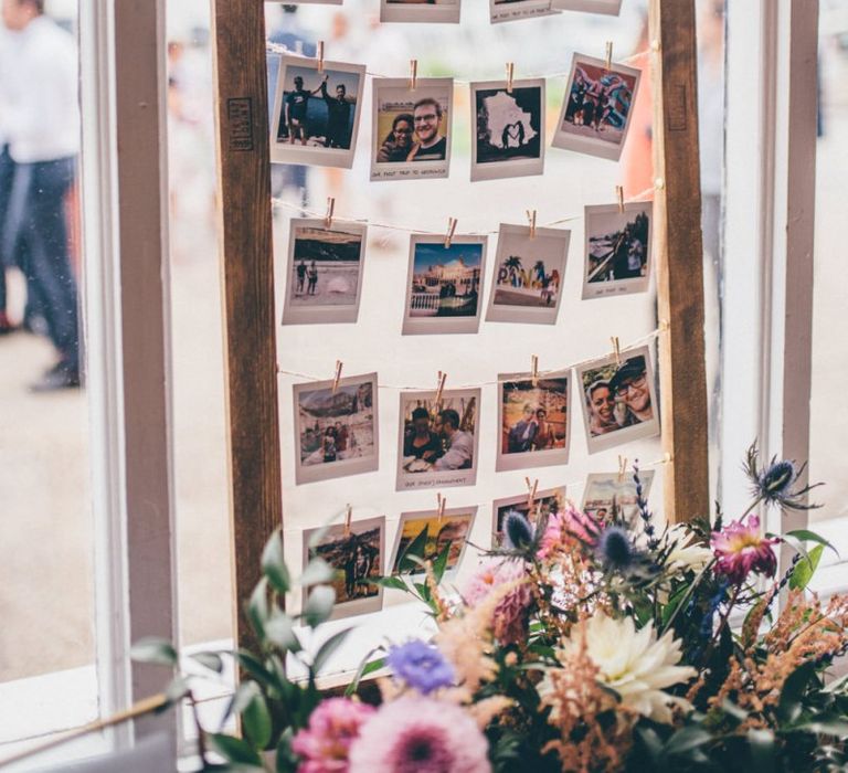 Polaroid guestbook at industrial styled city celebration with fairy light backdrop