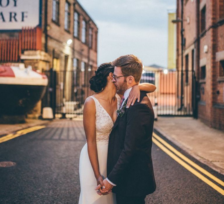 Bride and groom steal a moment at city celebration