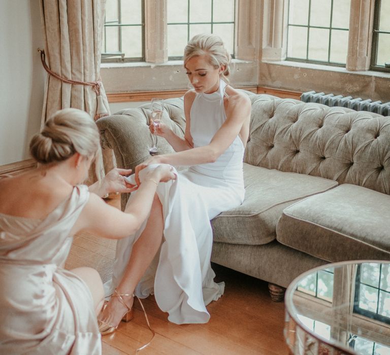 Bridal Préparations In Stella McCartney Wedding Dress With Bride Putting Wedding Shoes on